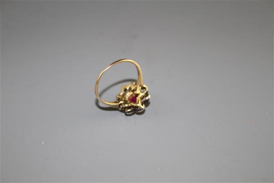 A yellow and white metal, ruby and diamond set oval cluster ring, (adapted),